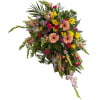 An easel spray consisting of yellow daisies, light pink gerbera daisies, snapdragons