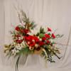This stunning arrangement is an abundance of everything Christmas.The decorated arrangement is