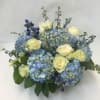 Our artisan handmade arrangement&#039;s overall theme is monochromatic with blues and whites.