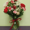 The perfect Christmas arrangement that includes Christmas ornaments and long lasting flowers!