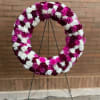 A 21 inch round wreath filled with carnations (colors of choice)