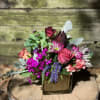 Champagne glass cube filled with mixed arrangement, colors and flowers vary on