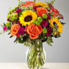 Our floral professionals weave together a blend of orange roses, sunflowers, violet