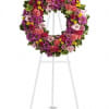A standing wreath includes vivid flowers such as green hydrangea, hot pink