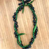 Kukui Nut lei wrapped with a thin ti leaf lei is a