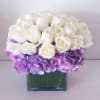 Elegant and clean low and lush arrangement composed of purple hydrangeas surrounded