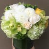 Clean and elegant low square arrangement in green, white and a touch