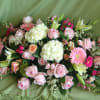 An assortment of blushing pinks and coral accented with soft ivory combine
