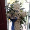 White cushion mums and white lilies and blue delphinium altogether with a