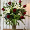 A dozen long stem red roses elegantly arranged with green hydrangea, white