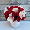 24 red roses comforted with white cymbidium orchids in a white container