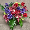 Modern design of Cymbidium orchids, roses and jewel tone colors. Assortment and