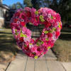 A 18 inch open heart filled with bright seasonal flowers colors of