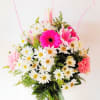 Cheerful mix of daisies, gerbera daisies, and lilies, arranged in a 5&quot;