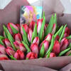 Hand tie bouquet of magnificent tulips in bright red tone.