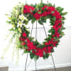 A beautiful white and red tribute heart wreath that calms, this easel