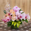 Mixed colored orchids accented with peach roses and light pink peonies. (TEF-004)