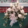 White carnations and roses with trailing ivy make this basket unique for