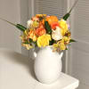 Cute clay vases with vibrant fall colors. Filled with roses, aster and