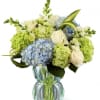 Clusters of blue and green hydrangea give this floral arrangement a fresh