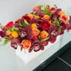 High-end roses, cymbidium orchids, kumquats, ranunculus, and high-end accent greens in a