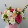 Box filled with roses, garden roses, peonies, hellebore