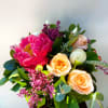 This is an elegant, fresh bouquet with peonies (seasonal), lilac (seasonal), peach