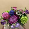  Beautiful vase of seasonal flowers in mixed shades of purples and