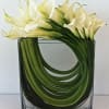 A Modern Calla Arrangement composed in a rectangular envelope glass vase