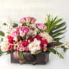Roses and hydrangeas in muted warm colors.