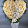 This giant heart is full of buttercream and white roses and accented