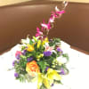  Multi tropical flowers with lilies, roses, orchids, statice, in a dish.
