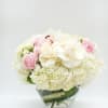 An elegant arrangement with fluffy hydrangeas, beautiful ranunculus and a touch of
