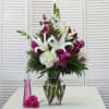 This Stunning Vase arrangement includes White Lilies as the focal point and