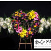 A custom funeral arrangement that spells out the word MOM with the