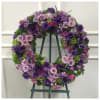 A beautiful tribute wreath of purples, lavender and green flowers.