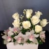 A pretty arrangement including white roses, and pink orchids