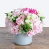White cylinder styled with pink hydranges, various shades of pink roses, white