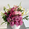 Lavender roses, Purple Peruvian lilies, delicate white stock, and more are arranged