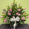 This pink and white arrangement is a beautiful funeral basket that is