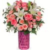Bursting with perfect pink roses and snow white lilies, this sparkling cut