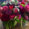 This Beautiful design of mix color roses, tulips. ranunculus, cymbidium orchids, and