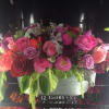 This Beautiful design of mix color roses, tulips. ranunculus, cymbidium orchids, and
