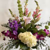 Premium flowers arranged in a clear glass vase