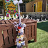 A keepsake broom decorated with silk flowers and wrapped in ribbon for