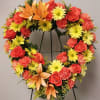 Made in a heart shape with asiatic lilies, roses daisies, carnation with