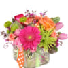 A bright and whimsical arrangement of cheerful flowers and ribbon