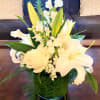 This elegant design is composed of White Lilies, Roses, Snapdragon, Stock, &amp;