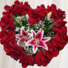 This arrangement contains roses and pink lilies. 