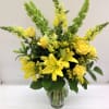 Roses, lilies, snapdragons, solidago and bells of Ireland beaming beautifully anywhere they